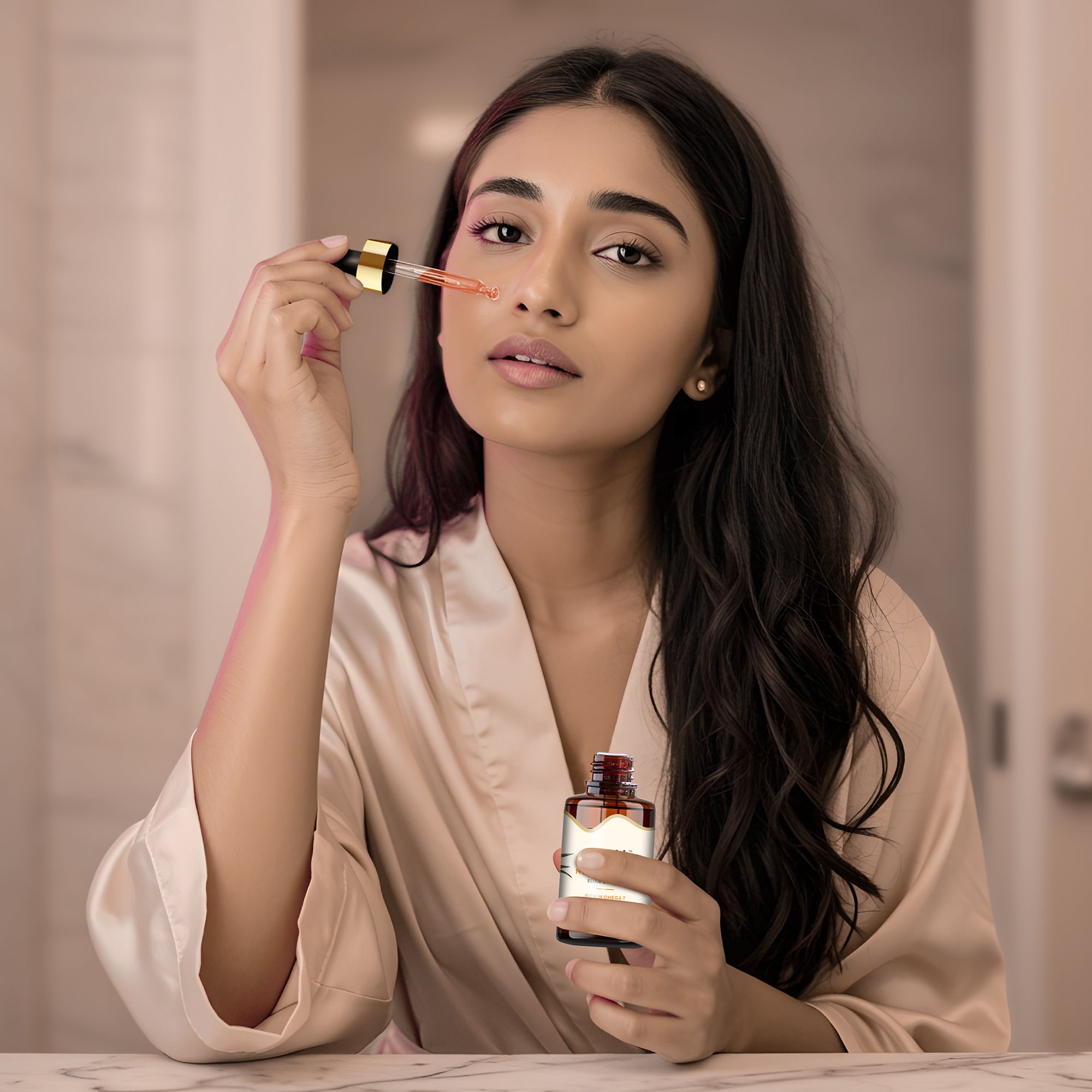 Woman applying a sea buckthorn nourishing oil with a dropper bottle in a bathroom setting