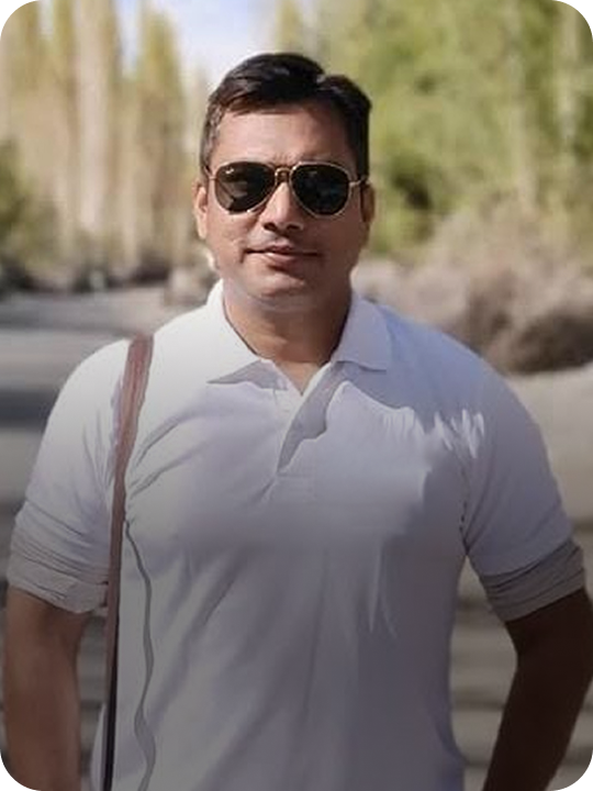 Man wearing sunglasses and a white t-shirt with a blurred outdoor background